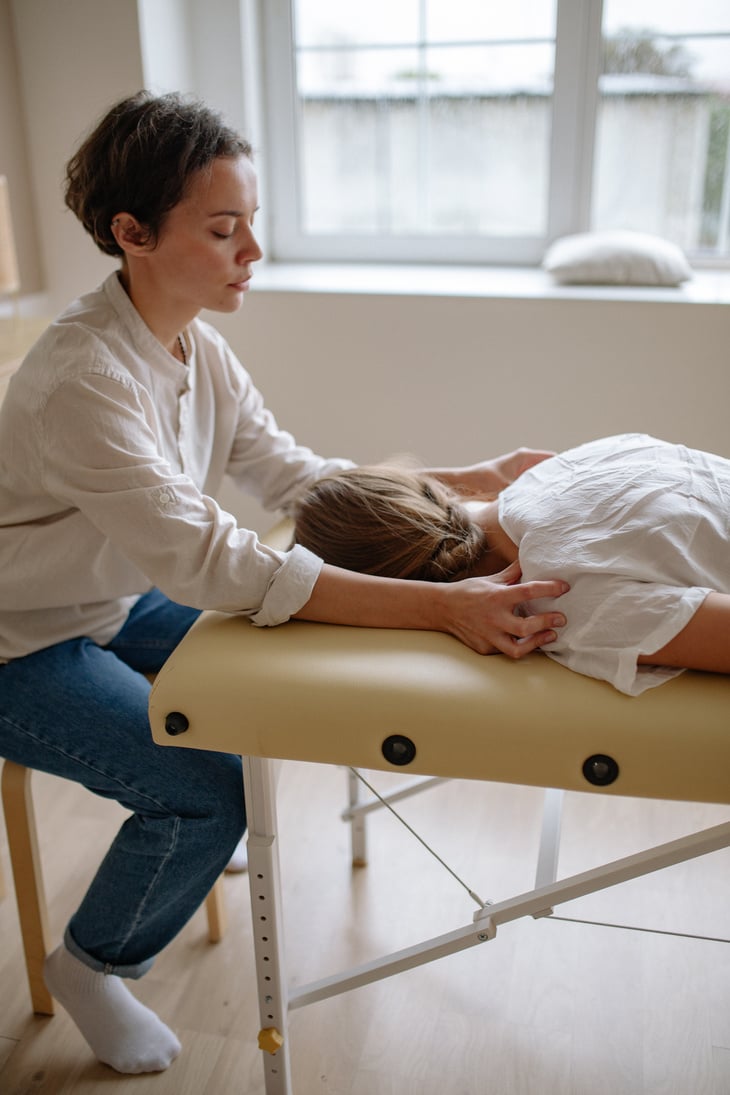 A Therapist Massaging Shoulders